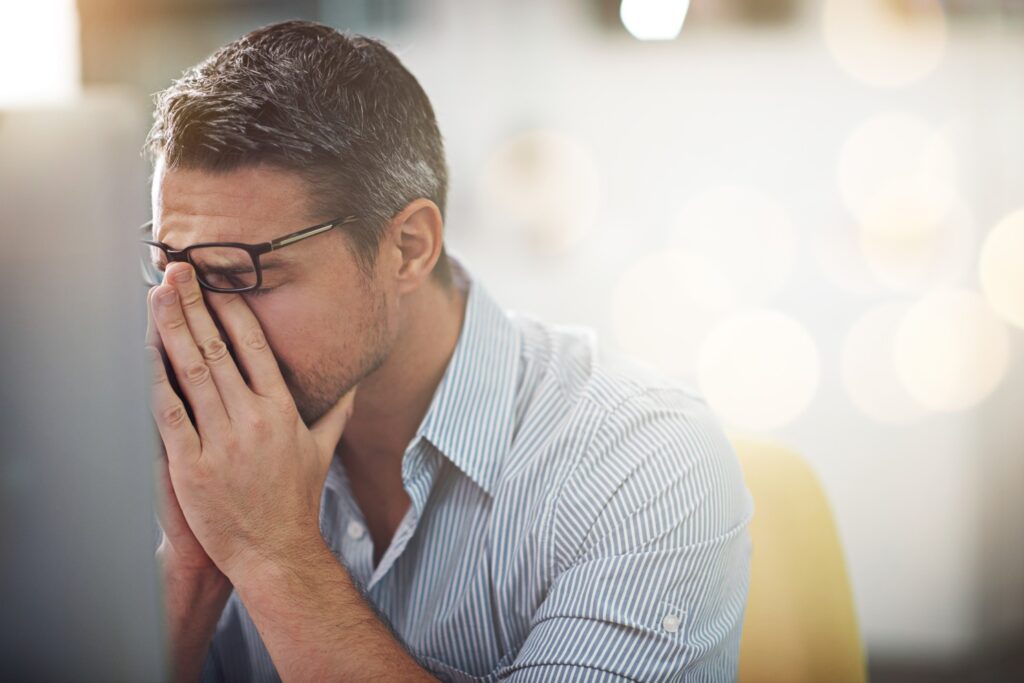 Man holding his face in his hands